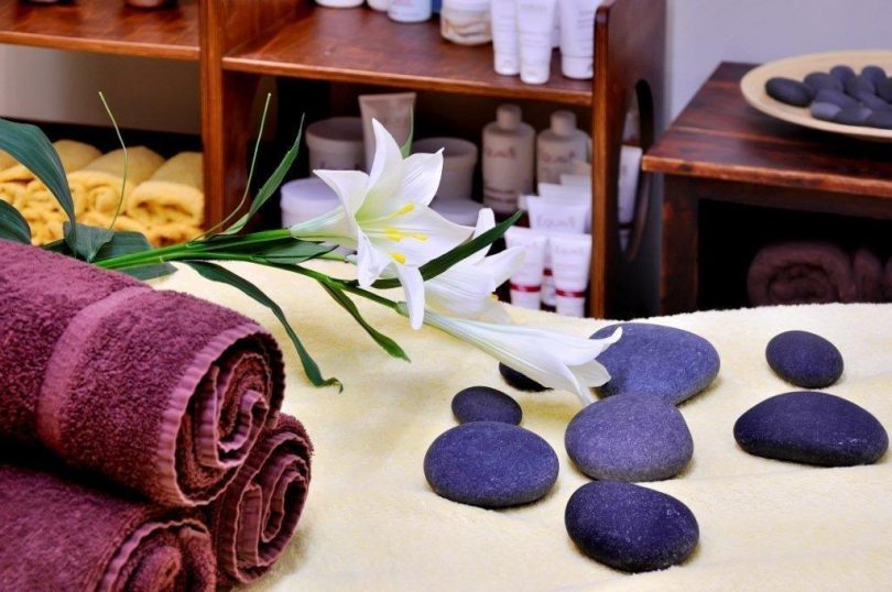 asciugamano viola, fiori e pietre