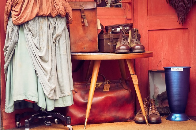 vestiti e scarpe di pelle usate sopra tavolino di legno