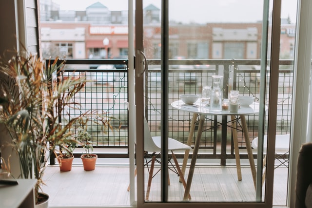 terrazzo con tavolino rotondo bianco sedie e piante