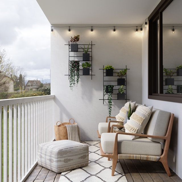 balcone con poltroncine di legno con cuscini bianchi pouf bianco e piante appese al muro