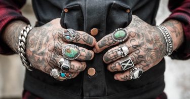 mani con tatuaggi e anelli