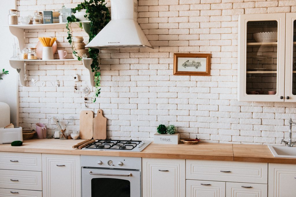 cucina con mattonelle bianche e piano in legno